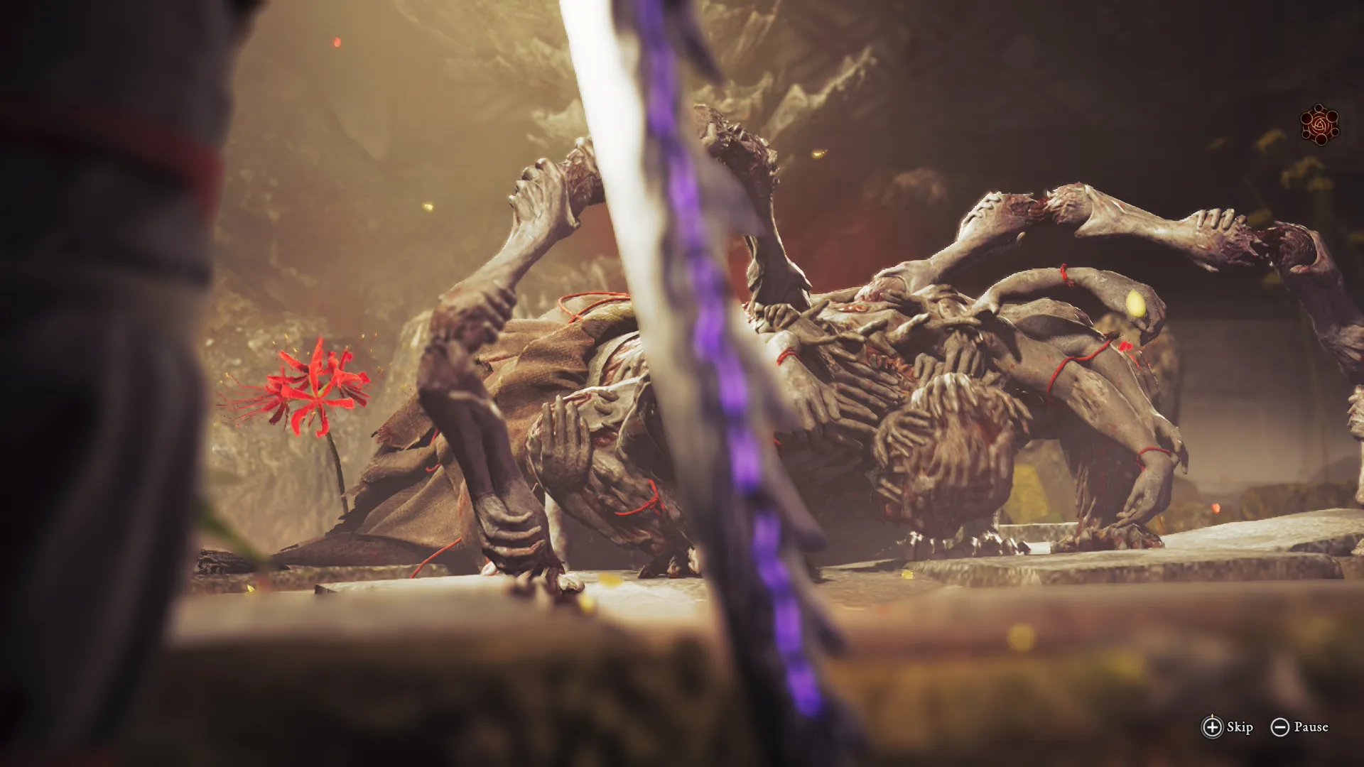A slain multi-limbed Genma sprawls across cracked stone, grey flesh split with glowing red seams, as a blurred blade passes in the foreground